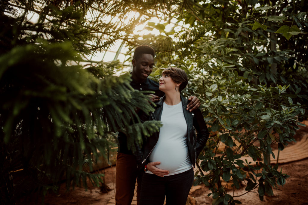 Couple aux Serres D'Auteuil à Paris lors d'une séance photo grossesse.