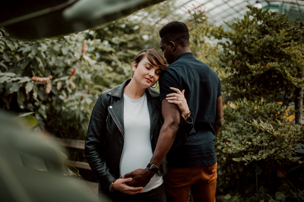 Couple aux Serres D'Auteuil à Paris lors d'une séance photo grossesse.